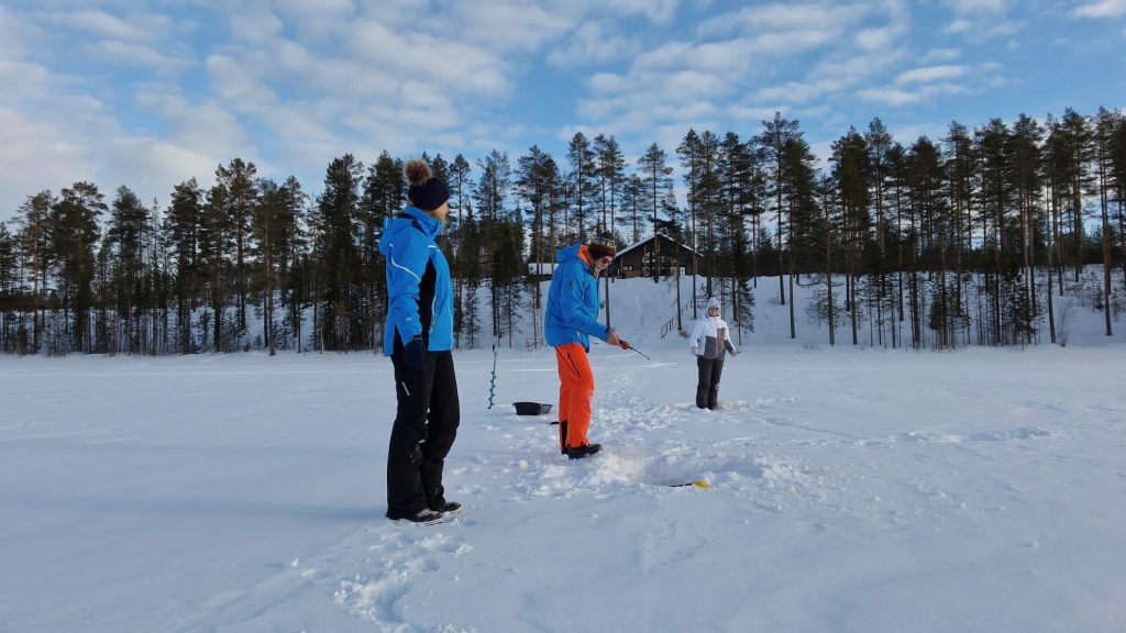 Our guest fishing on the ice, Villa Vasa behind them.