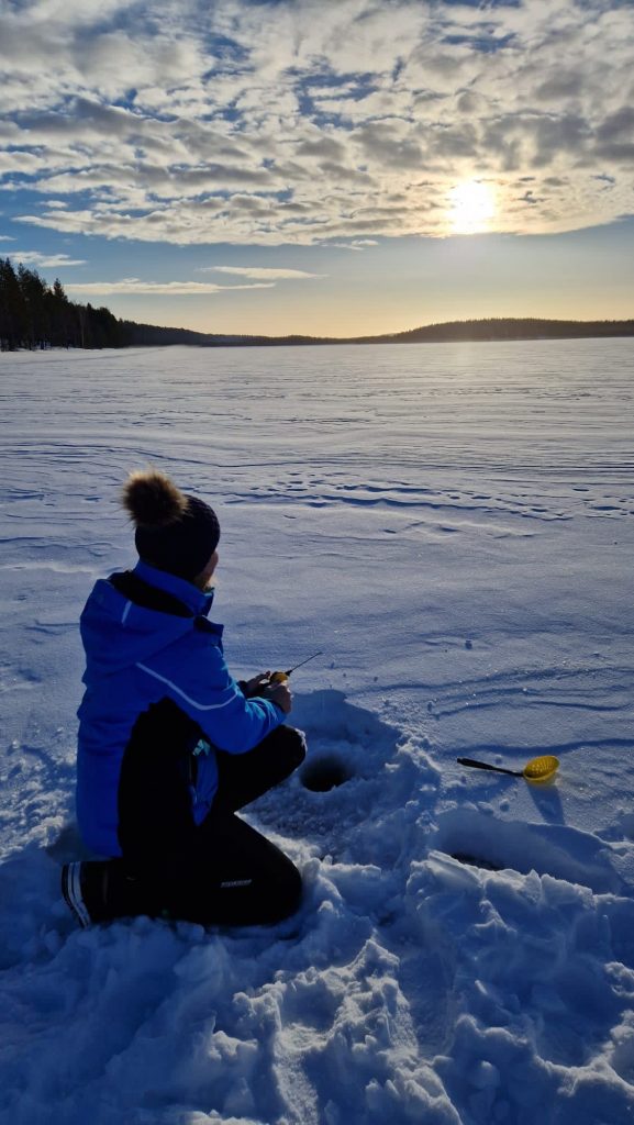 Our guest fishing on the ice in March next to Villa Vasa in Rovaniemi